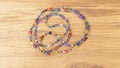 colorful bead necklace made of wood on wooden table 1 Royalty Free Stock Photo