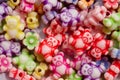 Colorful beads in the form of bears and flowers for making jewelry shot close-up on a white background Royalty Free Stock Photo