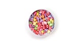 Colorful beads in the form of bears and flowers for making jewelry shot close-up on a white background Royalty Free Stock Photo