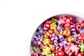 Colorful beads in the form of bears and flowers for making jewelry shot close-up on a white background Royalty Free Stock Photo