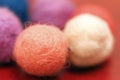 Colorful beads made of felt closeup. Macro photo on a red background Royalty Free Stock Photo