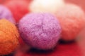 Colorful beads made of felt closeup. Macro photo on a red background Royalty Free Stock Photo