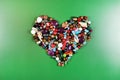 Colorful beads shells and stones in a shape of heart Royalty Free Stock Photo