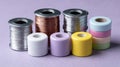 Colorful beads and wire spools for crafting on a purple background Royalty Free Stock Photo