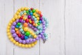 Colorful beautiful bright beads necklace on a wooden background Royalty Free Stock Photo
