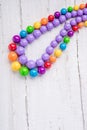 Colorful beautiful bright beads necklace on a wooden background by summer Royalty Free Stock Photo