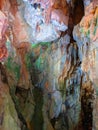 Colorful beautiful dark cave interior with ancient stalactites and stalagmites. Wild nature Royalty Free Stock Photo