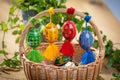 Beautiful, colorful hand painted Easter eggs, made of wood in a brown wicker basket Ã¢â¬â decoration of a holiday table during celeb