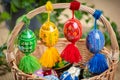 Beautiful, colorful hand painted Easter eggs, made of wood in a brown wicker basket Ã¢â¬â decoration of a holiday table during celeb Royalty Free Stock Photo