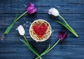 Colorful beautiful pink violet tulips and red heart in round wooden box on gray wooden table. Valentines, spring background. Royalty Free Stock Photo