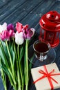 Colorful beautiful pink violet tulips and red lantern on gray wooden background. Valentines, spring background. Royalty Free Stock Photo