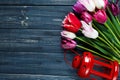 Colorful beautiful pink violet tulips and red lantern on gray wooden background. Valentines, spring background. Royalty Free Stock Photo