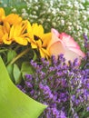 Colorful beautiful spring bouquet closeup. Roses, sunflower, purple flowers