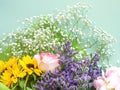 Colorful beautiful spring bouquet closeup. Roses, sunflower, purple flowers