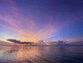 Colorful beautiful sunset, dawn with shades of pink, purple, blue. Calm sea with reflection of clouds in the water.