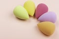 Colorful beauty sponges on pink background. Copy space.