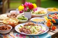 colorful beef taco buffet with fresh toppings on picnic table