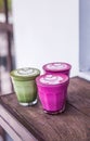 Colorful Beetroot, matcha lattes are on the wooden background