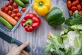 Fresh and colorful bell peppers and other vegetables on wooden table Royalty Free Stock Photo