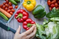 Fresh and colorful bell peppers and other vegetables on wooden table Royalty Free Stock Photo