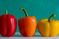 Colorful bell peppers in front of a colorful background