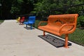 Colorful benches lined up. Yellow, red, blue, orange benches. Royalty Free Stock Photo