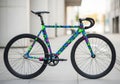 A colorful bicycle features a geometric pattern in bright green, blue, pink, and purple. It Royalty Free Stock Photo