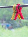 Colorful big cloth clamp on clothes line in a rainy day Royalty Free Stock Photo