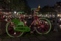 A colorful bike with flowers shot on a bridge on the Singel canal in Amsterdam at night Royalty Free Stock Photo