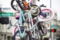 Colorful bikes tied around on a pole along the street during summertime, Portland, Oregon, USA