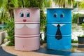 Colorful bin in a garden with cartoon painted