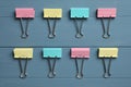 Colorful binder clips on blue wooden table, flat lay Royalty Free Stock Photo
