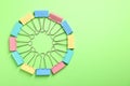 Colorful binder clips on green background, flat lay. Space for text Royalty Free Stock Photo
