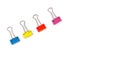 Colorful binder clips isolated on a white background