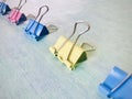 Colorful binder clips on a light blue background Royalty Free Stock Photo