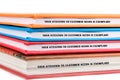 Colorful binders are stacked on top of each other, each displaying the phrase about exemplary attention to customer