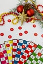 Colorful bingo game cards and numbers on white background with christmas ornaments Royalty Free Stock Photo