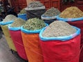 Colorful bins of spices at a Moroccan bazaar or market in Marrakesh medina.