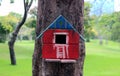 Colorful Bird Houses in the park Hanging on a tree, old bird house in park, bird house with natural green leaves background. Royalty Free Stock Photo