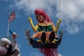 Colorful bird woman swinging in Festival of Fantasy Parade at Magic Kigndom 1.