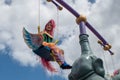 Colorful bird woman swinging in Festival of Fantasy Parade at Magic Kigndom 2.