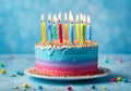Colorful birthday cake with lit colored candles.