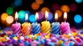 Colorful birthday candles are burning brightly on a table full of confetti
