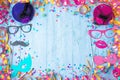 Colorful birthday or carnival frame with party items on wooden background. Royalty Free Stock Photo