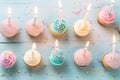 Colorful birthday cupcakes with burning candles on the table. Top view. AI Generated Royalty Free Stock Photo