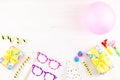 Colorful birthday party accessories on white. Wrapped gifts, confetti, balloons, party hats, decorations, copy space Royalty Free Stock Photo