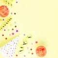 Colorful birthday party accessories on yellow. Wrapped gifts, confetti, balloons, party hats, decorations, copy space Royalty Free Stock Photo