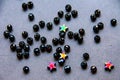 Colorful, black beads and stones isolated on grey background