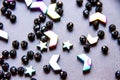 Colorful, black beads and stones isolated on grey background