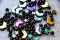 Colorful, black beads and stones on grey background